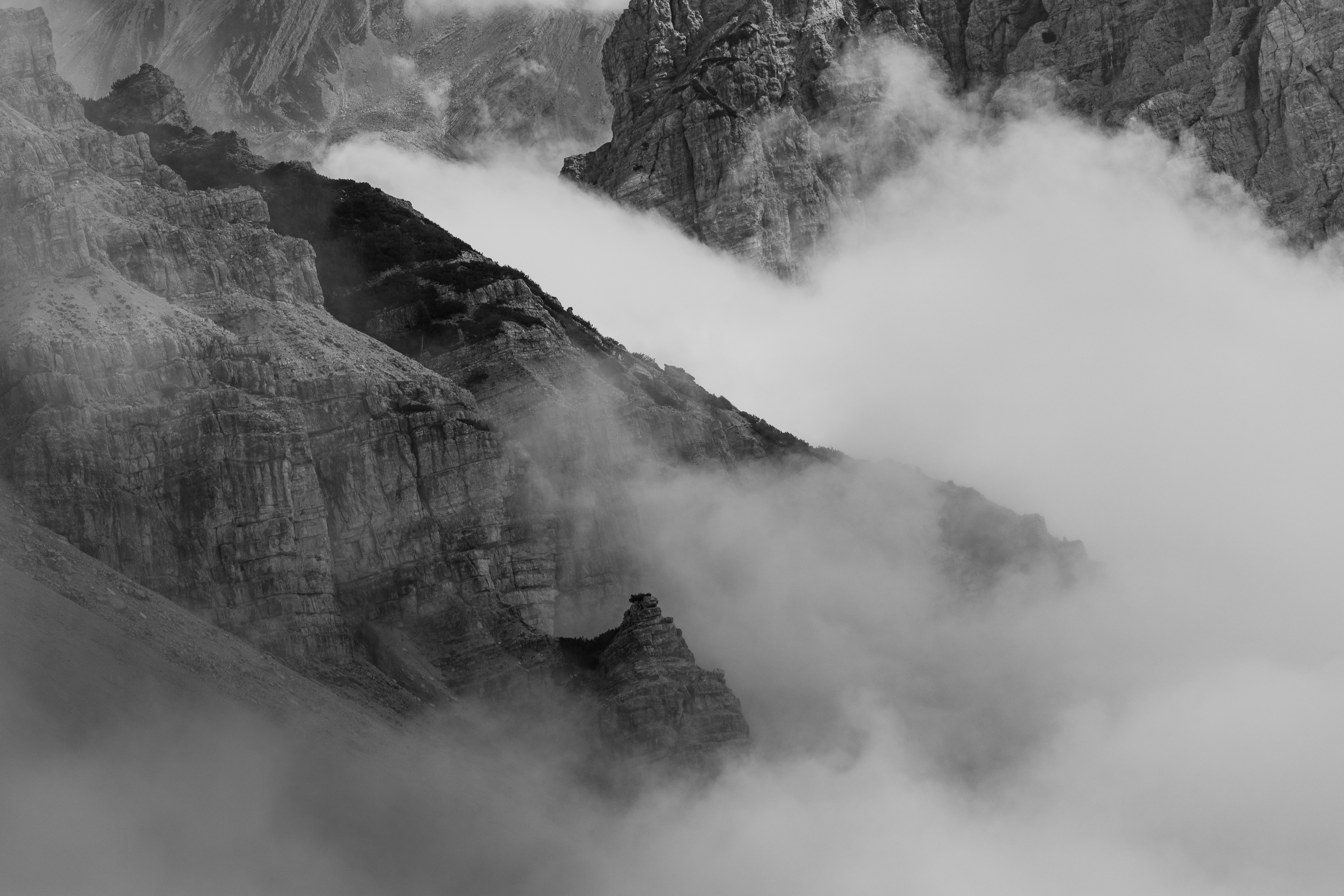 grayscale photo of mountain with clouds